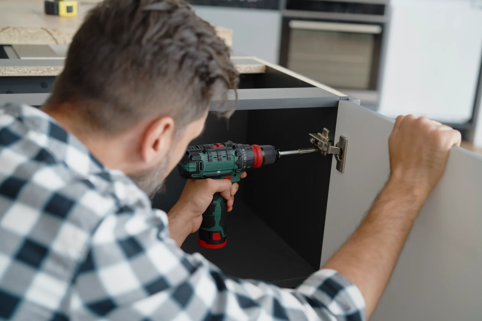 Man installing hinges in kitchen furniture 2024 11 27 17 08 56 utc